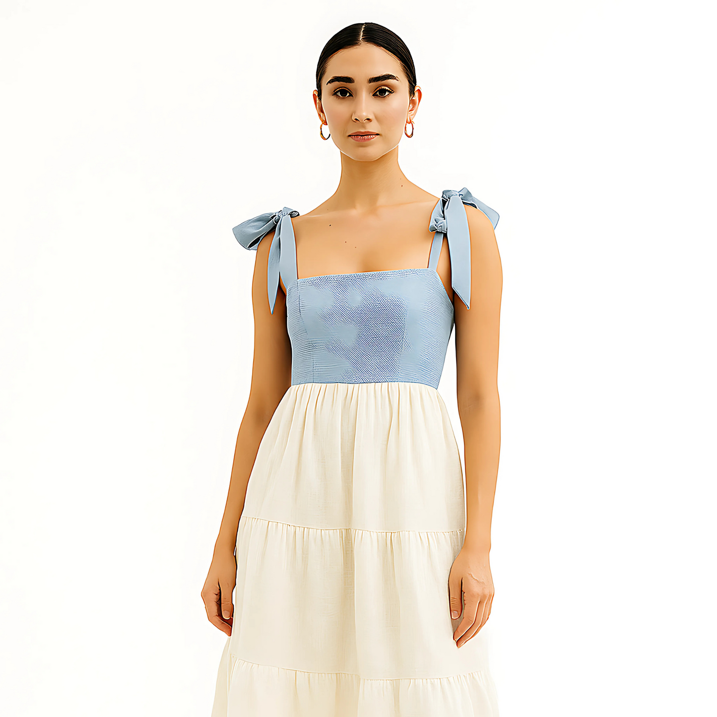 Model wearing Clio Tiered Midi Dress with bow-tied straps, square neckline, and gathered skirt in two-tone white and blue.