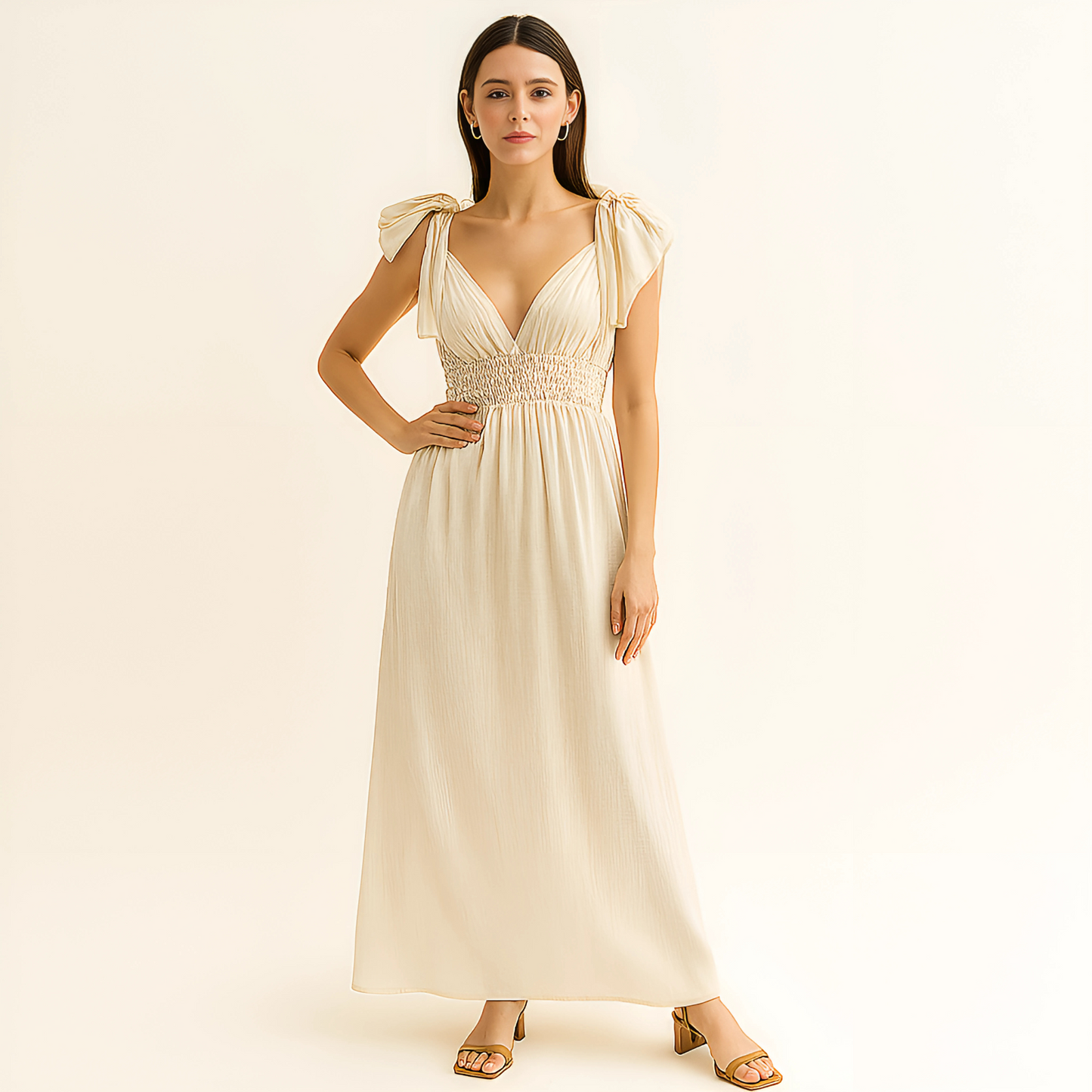 Delphine Ruffle Strap Maxi Dress in ivory with plunging neckline, ruffle tie straps, and open back, ideal for beach events and bridal settings.