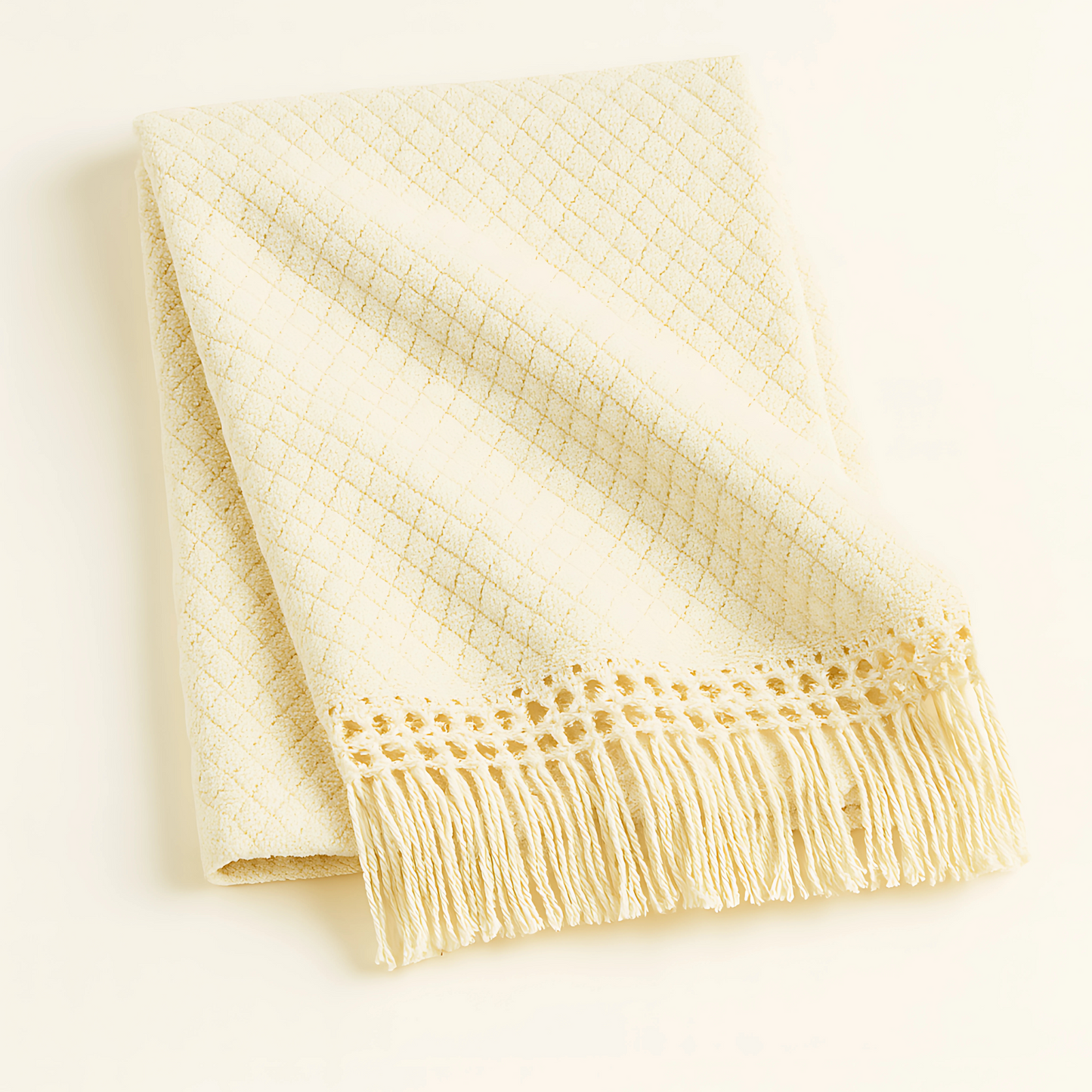 Luxury cream resort blanket with fringe detailing, ideal for lounging and spa relaxation. Oversized and crafted for upscale gifting.