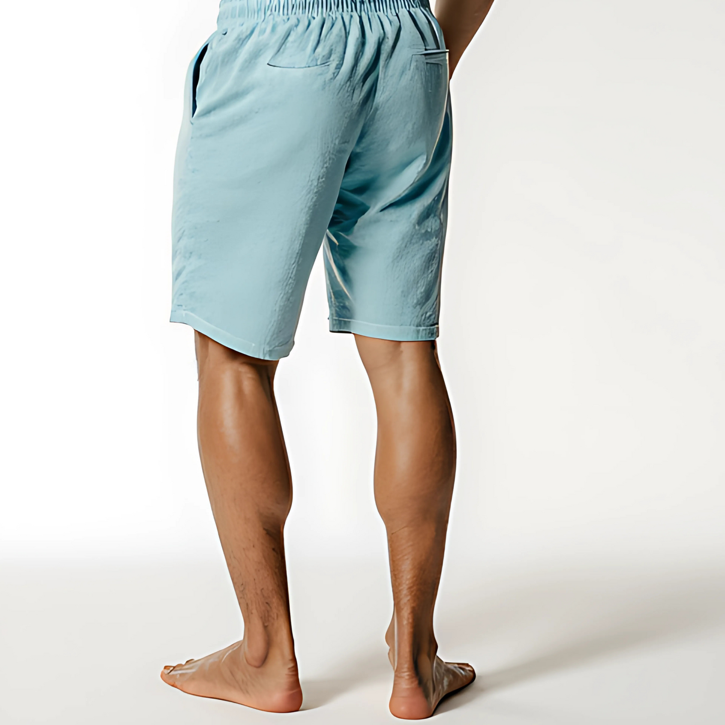 Model wearing light blue Resort Terry Swim Shorts, featuring elastic waistband and side pockets, captured from the back view.