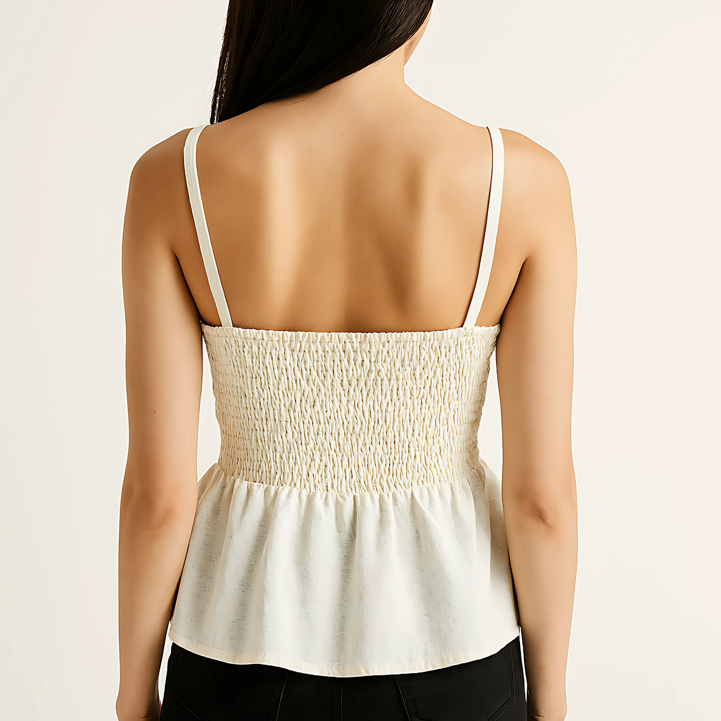 Back view of a woman wearing an ivory shirred peplum cami with adjustable straps and smocked back, ideal for summer outfits.