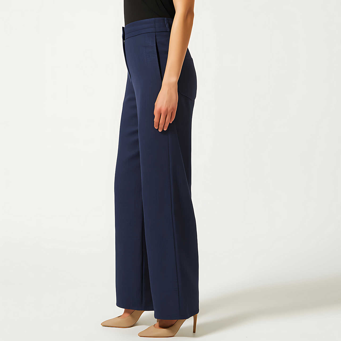 Model wearing Cadence Wide-Leg Trousers in Midnight Navy, showcasing elegant design with pleats and minimal side pockets.
