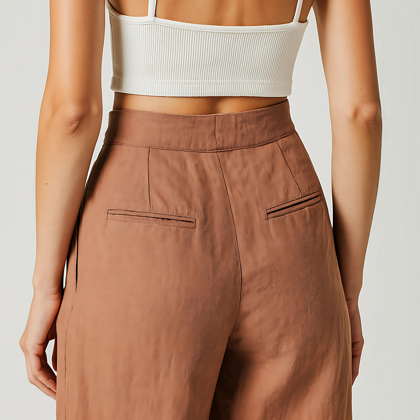 Back view of Solana Linen Trouser in terracotta, featuring wide-leg design and subtle pleats.