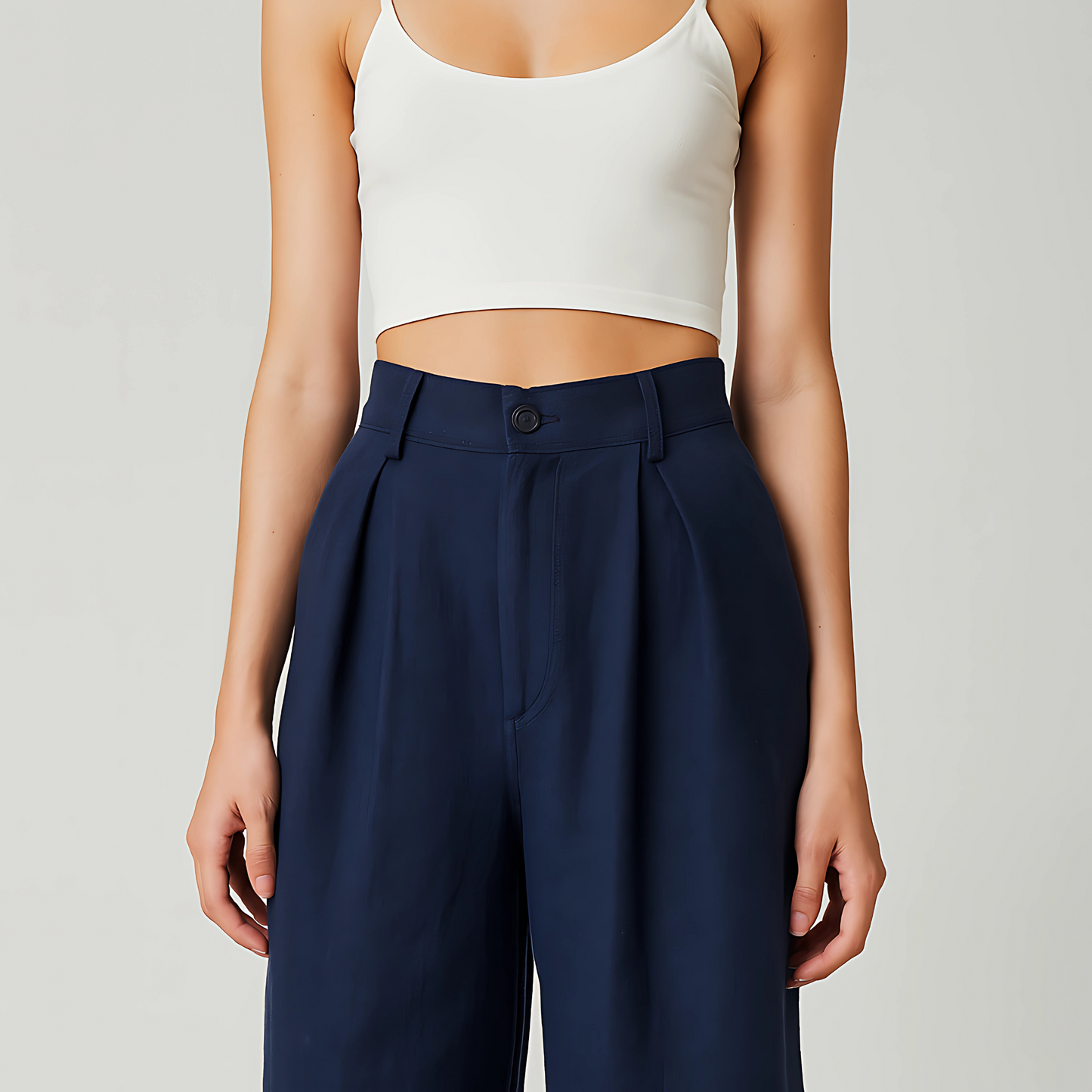 Model wearing Solana Linen Trouser in Navy featuring high-waisted, wide-leg design with front pleats for a chic, breezy look.