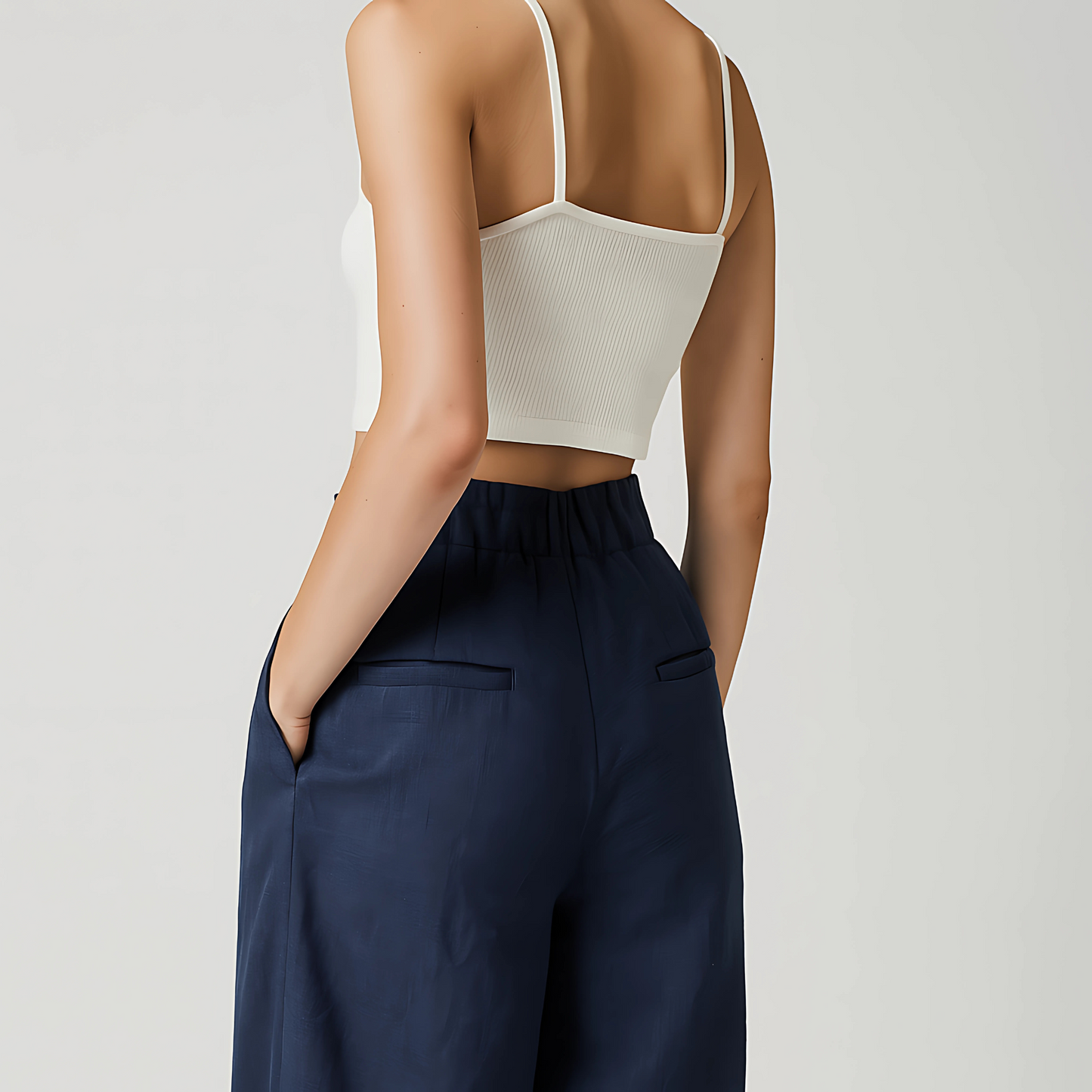 Back view of model wearing Navy wide-leg Solana Linen Trouser with high waist, paired with white top, ideal for resort or travel wear.