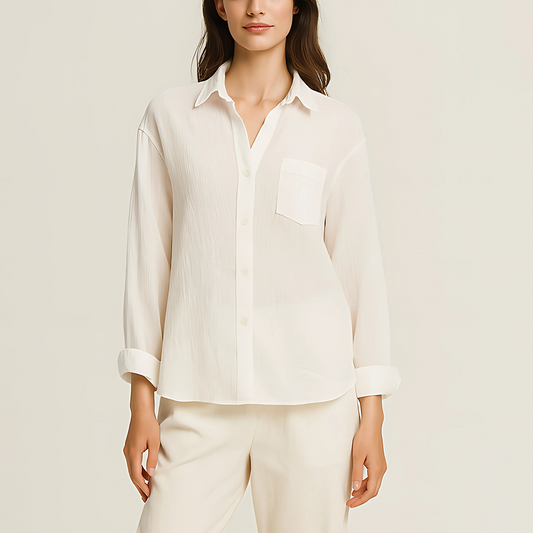 Aire Button-Down Shirt in white cotton gauze with long sleeves and a chest pocket, showcasing a lightweight and breathable design for summer.