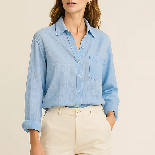 Azure Breeze Gauze Shirt in soft blue cotton, perfect for layering. Lightweight and semi-sheer with button-down front and pocket detail.