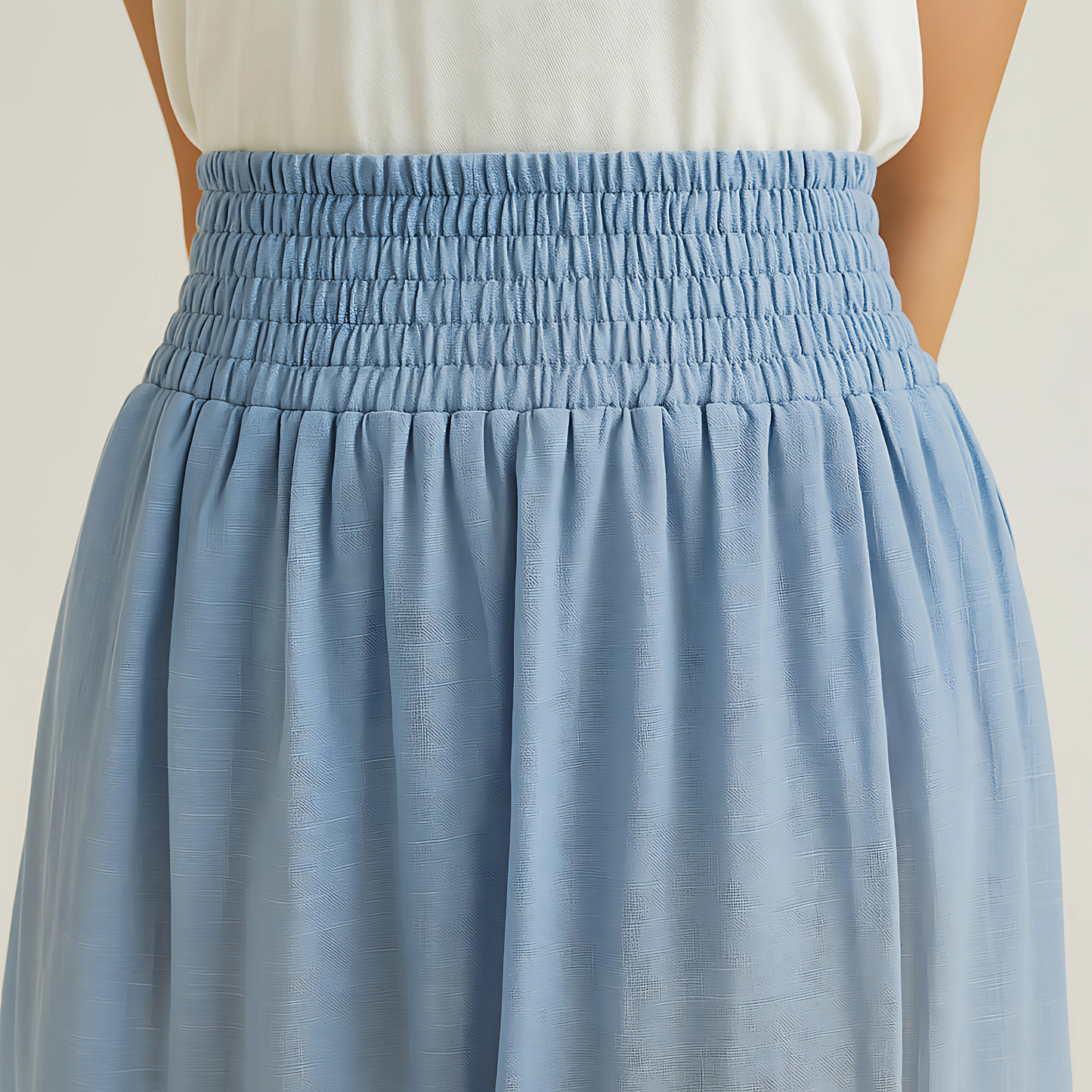 Isla Elastic Midi Skirt in Cloud Blue with wide waistband, perfect for resort or travelwear. Lightweight cotton-voile fabric.