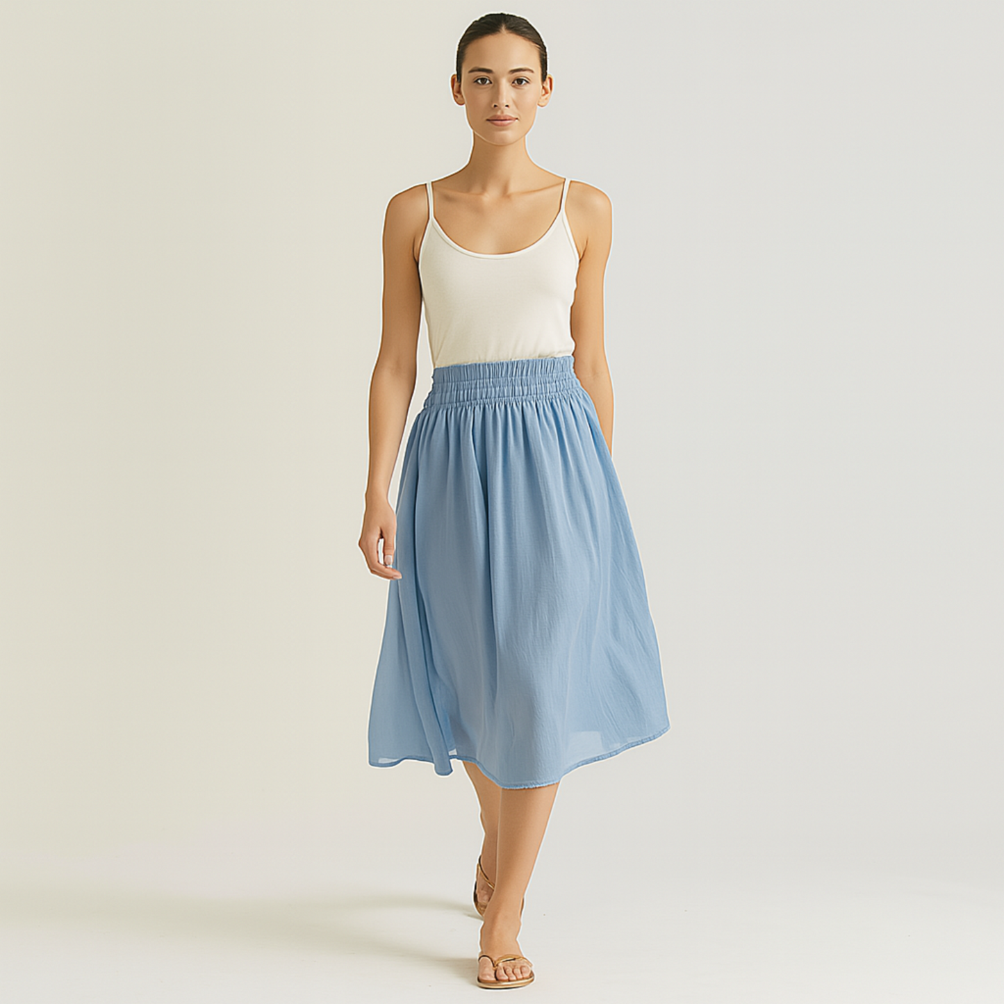 Woman wearing Isla Elastic Midi Skirt in Cloud Blue with elastic waistband, styled for resort, spa, or travelwear.