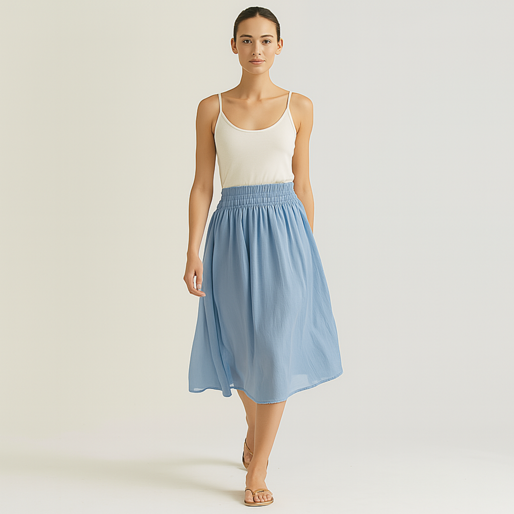 Woman wearing Isla Elastic Midi Skirt in Cloud Blue with elastic waistband, styled for resort, spa, or travelwear.