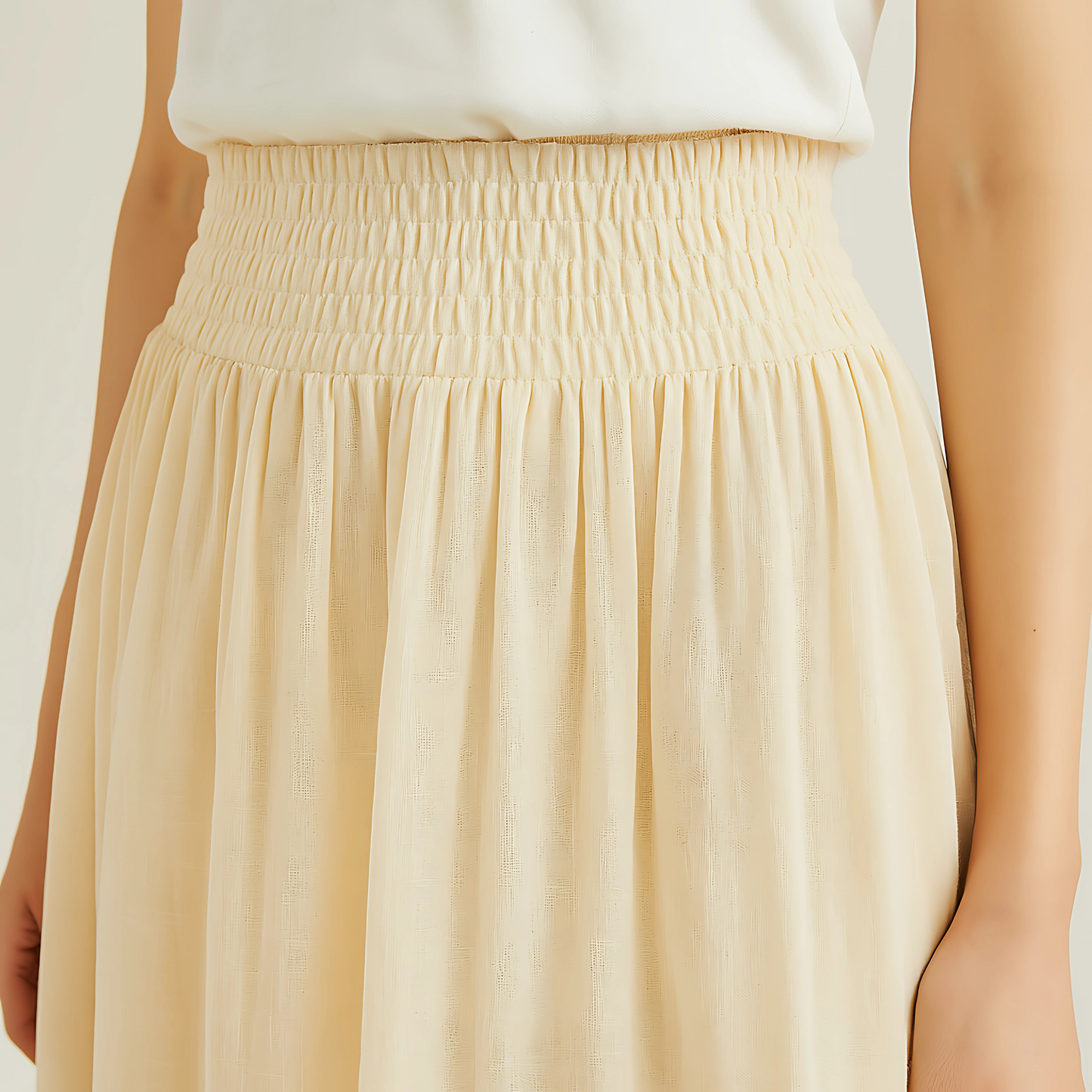 Close-up of Isla Elastic Midi Skirt in Vanilla with wide elastic waistband, perfect for resort, spa, or travelwear; cotton-voile fabric.