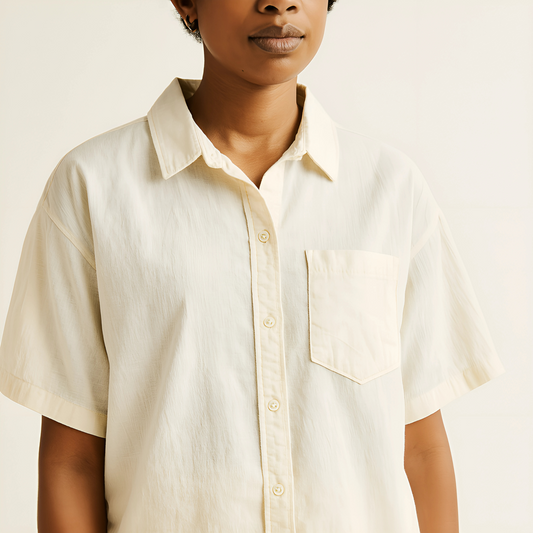 Unisex oversized camp shirt in natural color, featuring a relaxed fit, short sleeves, and a camp collar, made from lightweight cotton-linen.