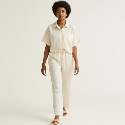 Model wearing an oversized natural camp shirt, unisex with short sleeves, perfect for relaxed casual wear or contemporary work attire.