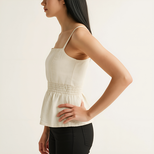 Side view of Shirred Peplum Cami in ivory, with square neckline and adjustable straps for summer collections.