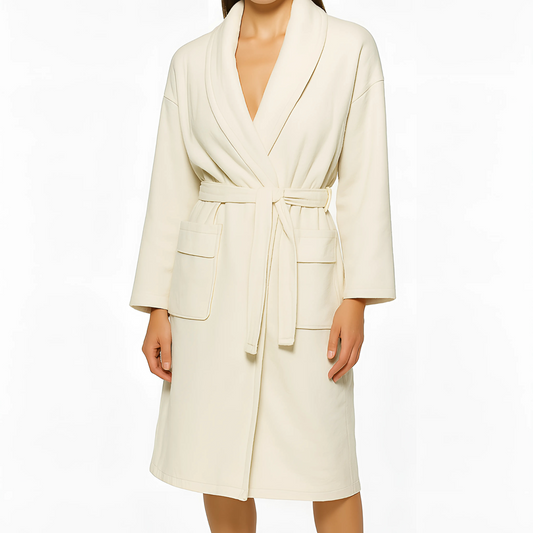 The Aedon Spa Robe in ecru with shawl collar, patch pockets, and self-tie belt, ideal for spa and wellness environments.
