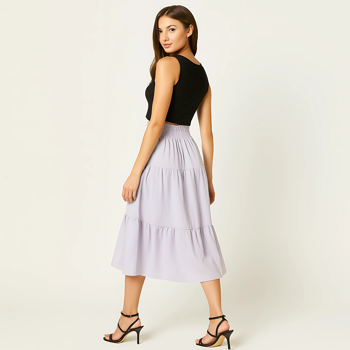Woman wearing Luma Cotton Midi skirt in soft lilac. Tiered design, high-rise waistband. Ideal for resortwear, spa retail, and spring fashion.