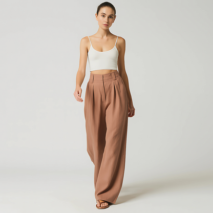 Woman wearing Solana Linen Trouser in Terracotta, featuring a wide-leg and high-waist design for elegant resort and travel fashion.
