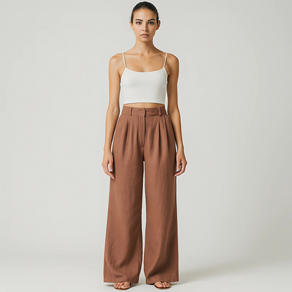 Wide-leg Solana Linen Trousers in terracotta, featuring a high-waisted fit and subtle front pleats, ideal for resort wear and travel.