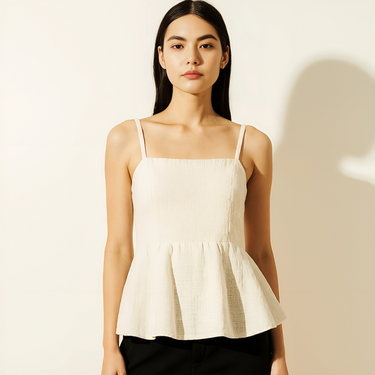 Ivory tie-back peplum top with straight neckline and flared hem, perfect for resortwear or modern feminine outfits.
